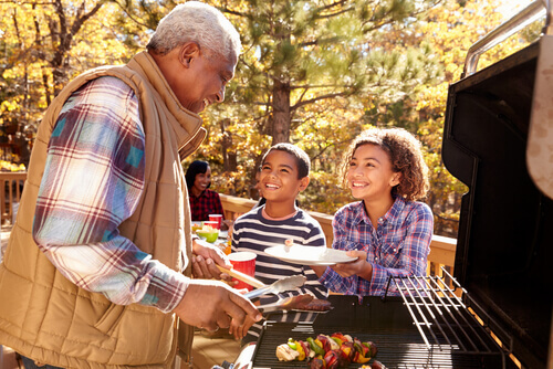 Grandkids and grandad grilling