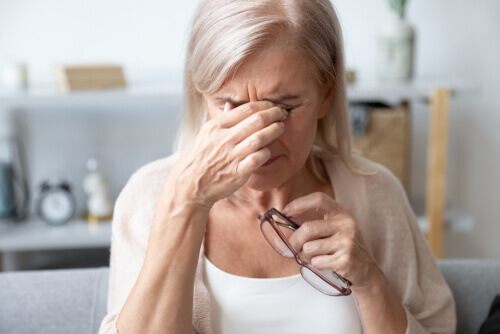 Mature woman rubbing eyes