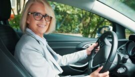 Woman wearing glasses in driver's seat