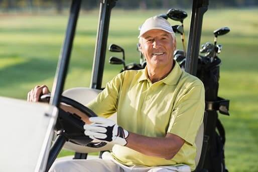 Mature man in golf cart