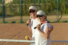 Older couple on the tennis court