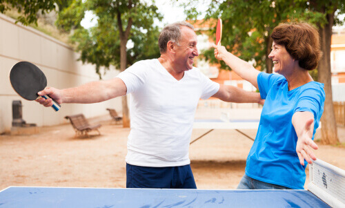 Older couple playing ping pong