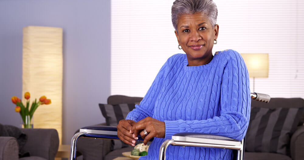 Beautiful mature woman in wheelchair looking at camera