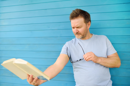 Man reading without glasses