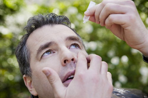 man putting in eye drops 