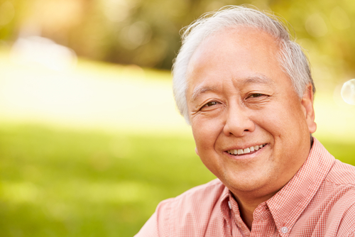 An elderly gentlemen smiling at the camera