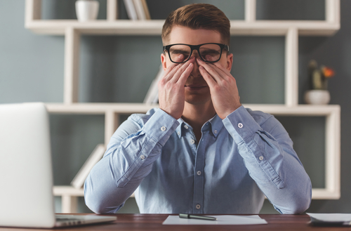 Man rubbing his eyes