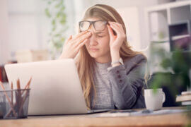 Woman rubbing her dry eyes