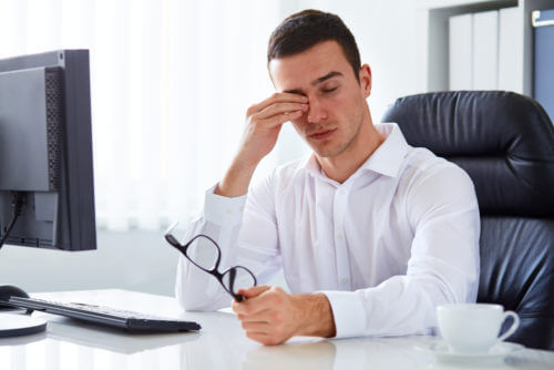 Young man rubbing his eyes