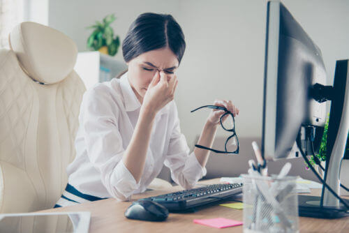 Young woman rubbing her eyes